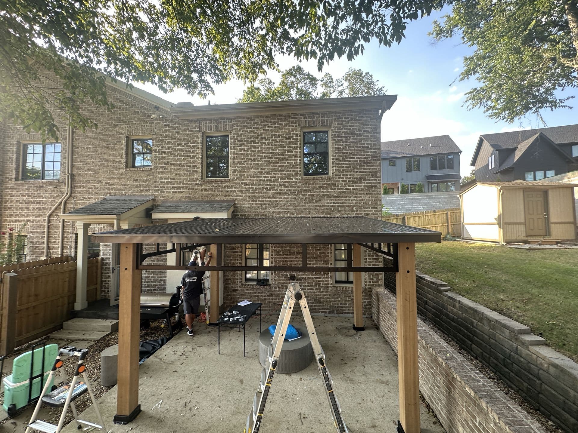 Vicmar crew assembling a hardtop gazebo in a Nashville backyard